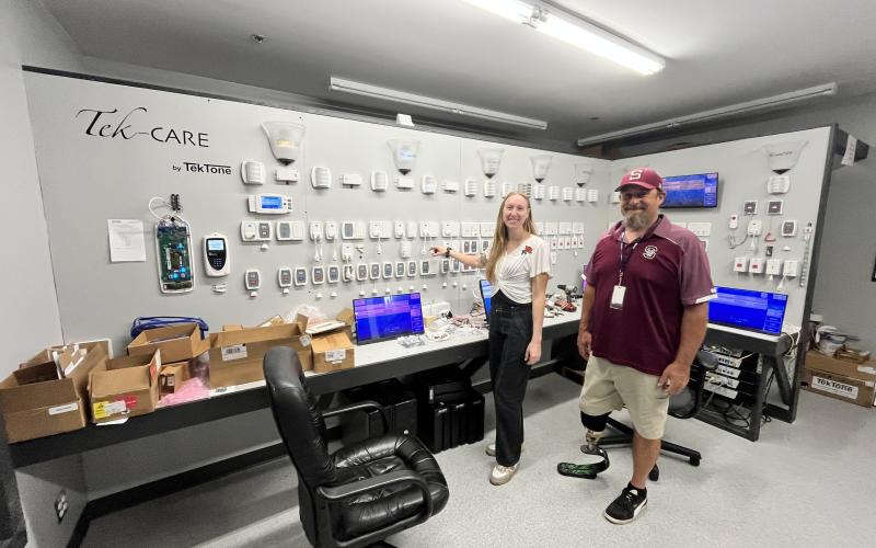 Swain High's Ian Roper takes a tour at TekTone with Amber Mauthe, technical support manager, as part of the Kenan Fellows Program.