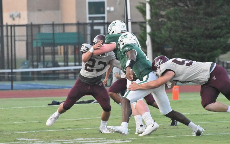 Maroon Devils defensive players Skeet Cook and Grady Lewis make it difficult for Charlotte Country Day to advance the ball in the opening season game last Friday.