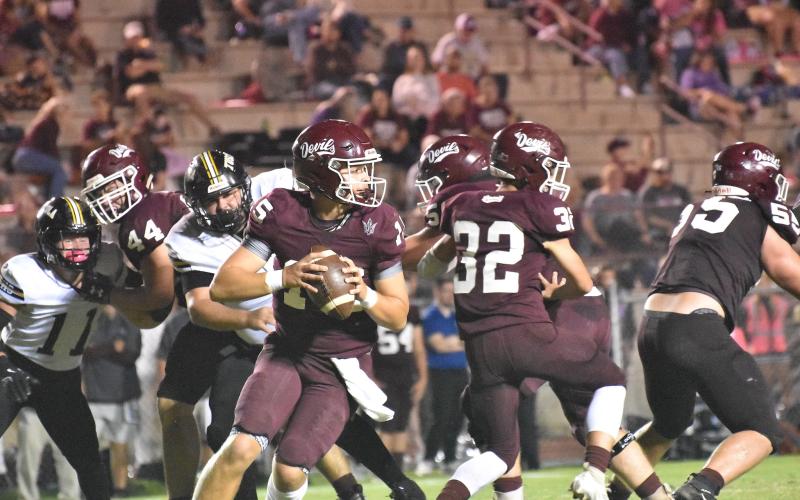 Swain’s Quarterback Jon Stephenson looks for an opening down the field as he prepares to connect with a receiver.