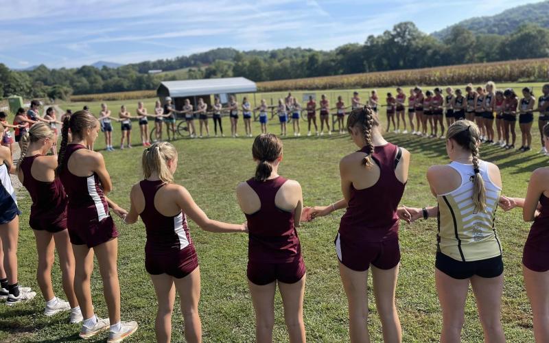 The women’s teams all joined together and linked hands for a group prayer before the race at Kituwah.