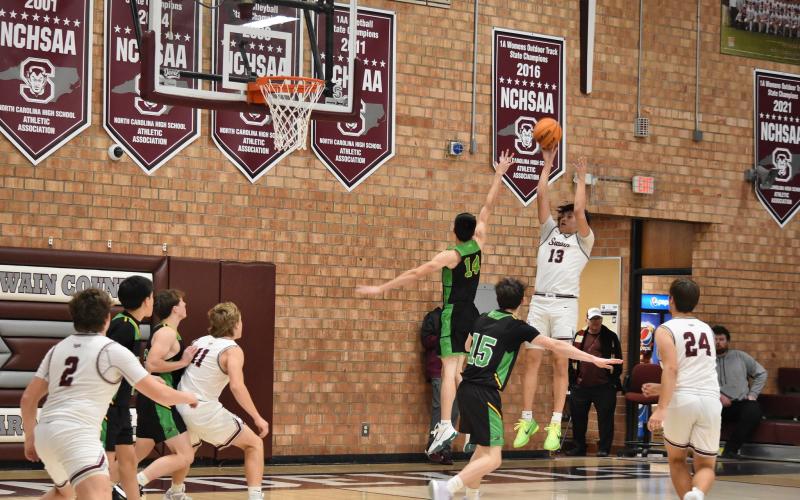 Jaden Wade, senior, shoots, with Druw Cody (11) and Jon Stephenson (24) ready for the assist.