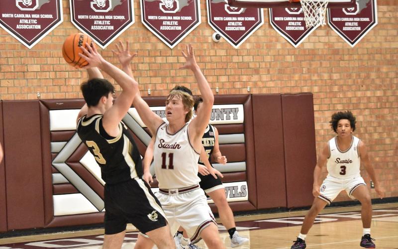 Maroon Devil Druw Cody, junior, tries to prevent a pass in the home loss against Hayesville. Cody was the top scorer for the Devils in the conference game.