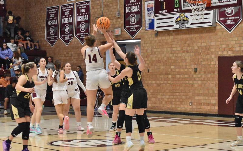 Lady Devil Molleigh Woodard, junior, makes good on a three-point shot in the home game last Friday.