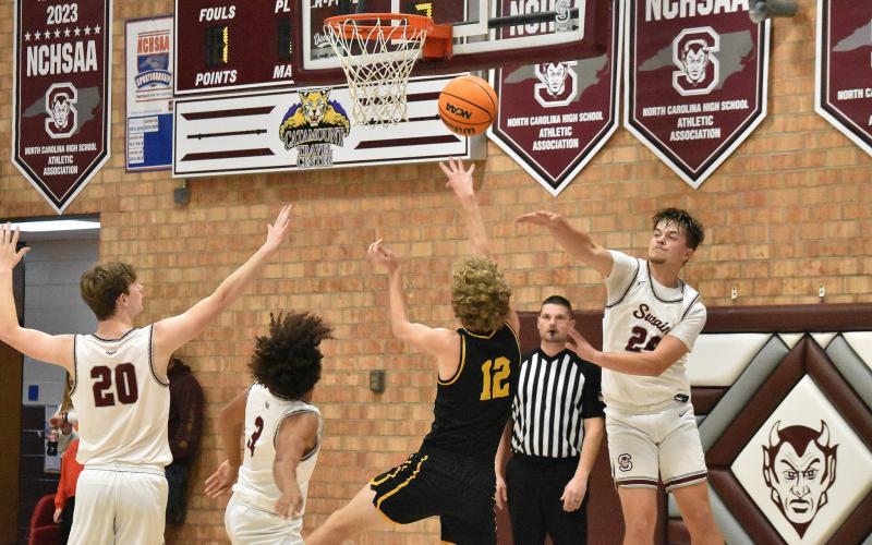 Maroon Devils from left Owen Medlin, Zeke Glaspie and Jon Stephenson all reach to recover the ball in the home loss against Murphy.