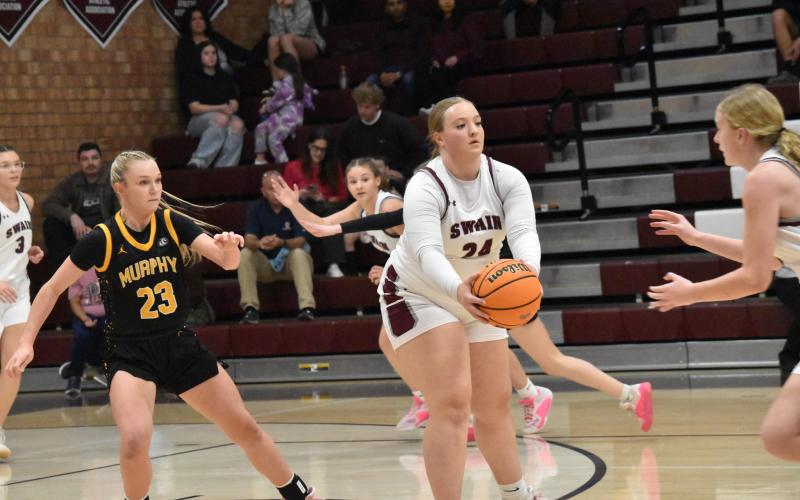 Faith Woodard, senior, hands the ball off to a teammate in the Murphy game. Woodard was recognized during Senior Night.