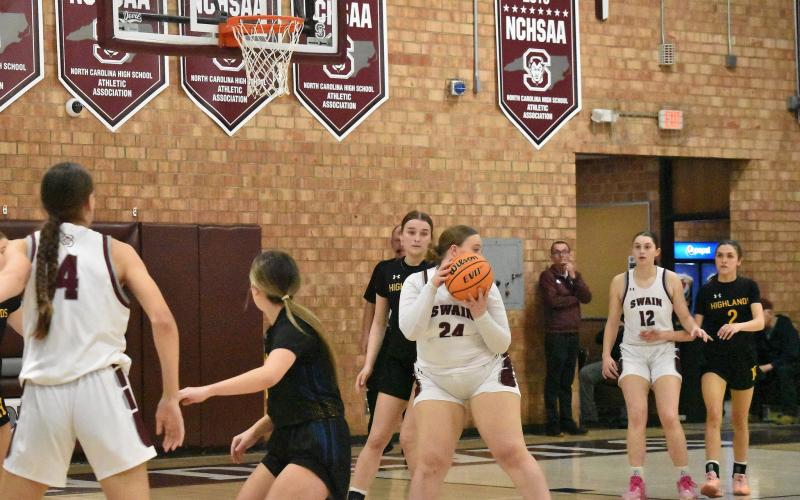 Lady Maroon Devil Faith Woodard looks to pass in the home game against Highlands.