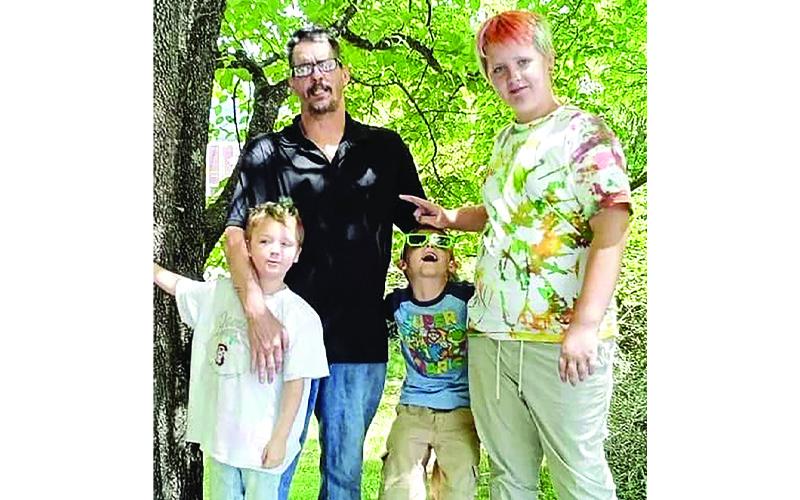Submitted photo. Father Nathaniel “Scott” Jackson, 47, who died in the fire, stands with children Nathaniel Jr. (left to right), Anthony and Landon in a recent family photo.