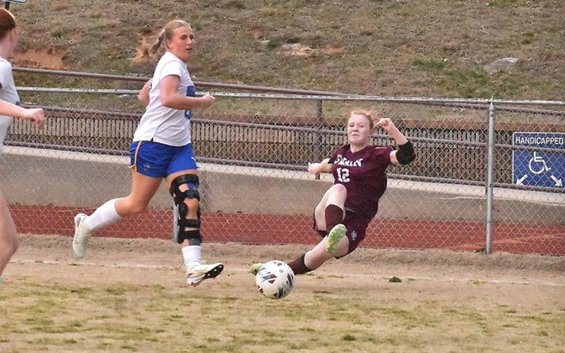 Photo/Joanna McMahan.  Claire Ball makes a defensive play against the Highlanders at home Thursday, March 13. Lady Devils beat the team 4-1.