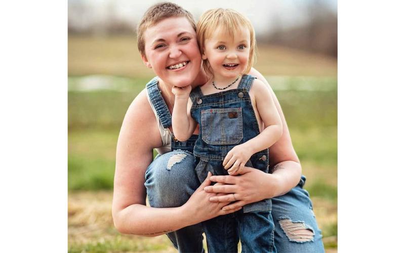 Photo/Kurstin Carroll.  Catie Hogue-Millard holds son Thatcher in celebration of his second birthday at Darnell Farms March 2. Husband Chevy Millard has been by his family’s side throughout his wife’s health problems.