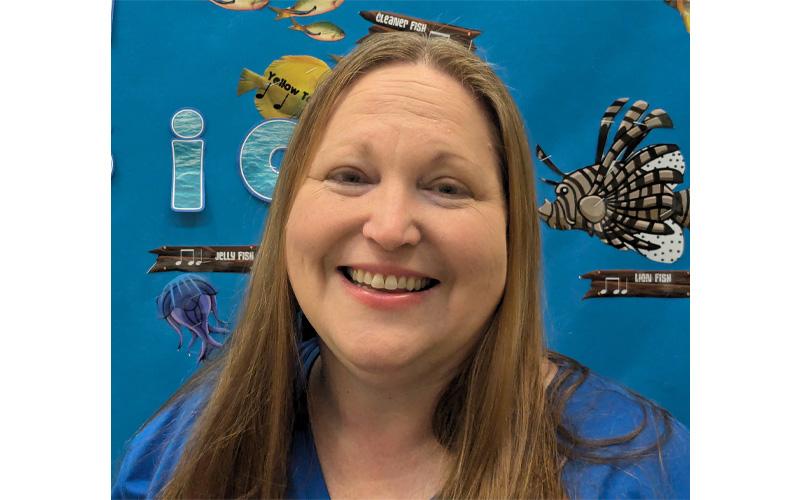 Submitted photo.  Swain County East Elementary Teacher of the Year Rachael Lewis stands in front of her classroom bulletin board Friday, April 11. Lewis started teaching at Swain County Schools in 2006.