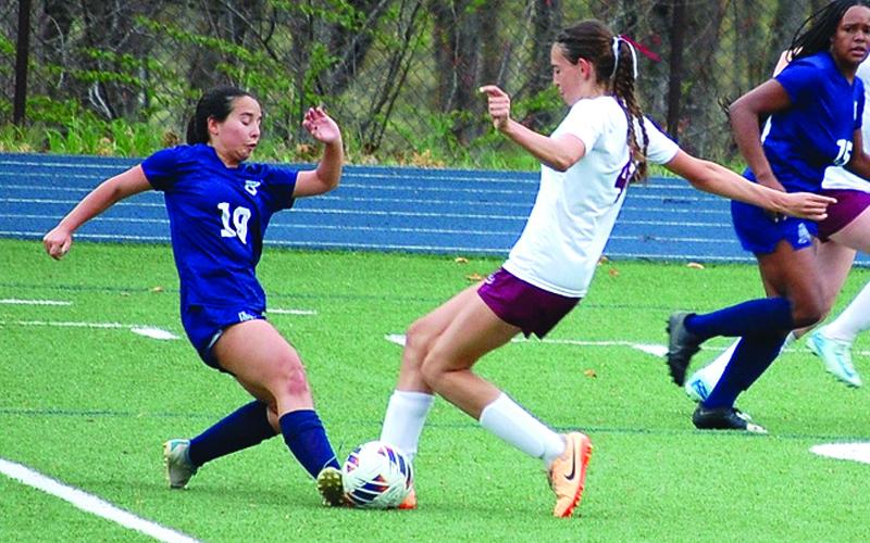 Photo/Brittany Blankenship.  Madison Blankenship challenges the ball against Asheville School Blues on Monday, March 31 . The Lady Devils took the 1-0 win.