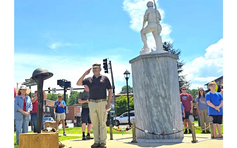 SMT photo/Sara Eisinger.  Vaughn Benner, retired US Army chaplain, pays tribute to fallen soldiers during a remembrance ceremony at the memorial monument in front of Swain County Visitor Center and Heritage Museum on Monday afternoon. Benner delivered the invocation and benediction.