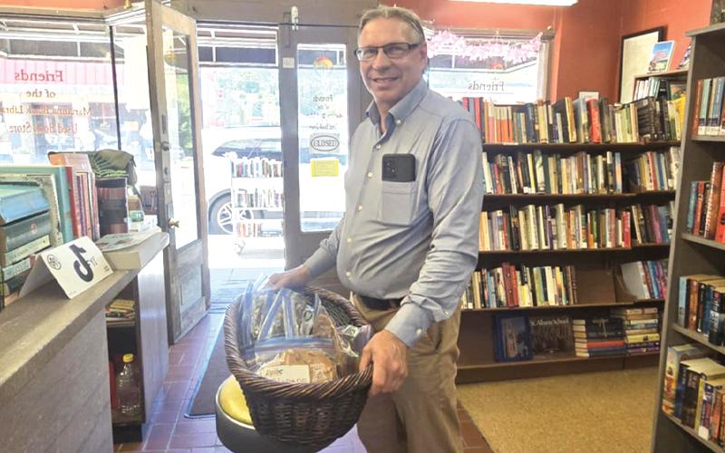 SMT photo/Sara Eisinger.  Pastor Kevin Linkinhoker with 12 varieties of peanut brittle to collect funds for church repairs after a large tree fell through its roof in January.