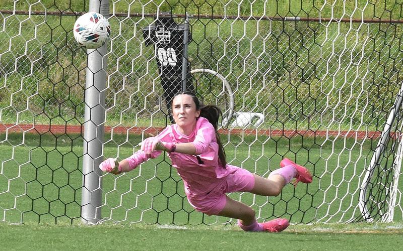Photo/Joanna McMahan. Senior goalkeeper Gracie Sutton makes a diving save in goal against Bethany Community School Wolves at home Thursday, May 15. Gracie topped off her high school career with one of her best games.
