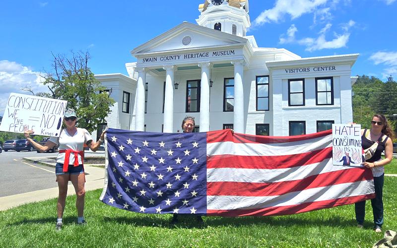 SMT photo/Sara Eisinger.  Jacqueline Ortlip (left to right), Lola Carlisle and Carli Beisel support democracy on the corner of Everett and Main streets Saturday, June 14. Swain County Democratic Party members and supporters held a peaceful demonstration. More than 250 Swain County resdients and visitors attended the local “No Kings” demonstration in Bryson City Saturday, June 14.