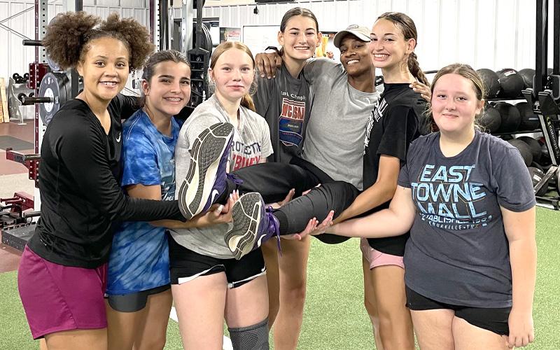 Photo/Joanna McMahan.  Swain High School Varsity Basketball Coach Nadia Marshall, center, is carried away by six Lady Devils at the school’s gym last week. 15 Lady Devils participate in Marshall’s basketball camp.