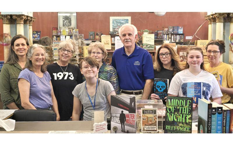SMT photo/Sara Eisinger.  Friends of the Marianna Black Library volunteers Patricia Gott (front, center); (middle, left to right) Carolyn Allison and Rilyn  Anderson; (back, left to right) Joia Goforth, Marcia Mycko, Helen Holman, Monte Dunten, Hannah Anderson and Deanna Booth get together at Friends of the Marianna Black Library Used Bookstore on Everett Street July 27. The bookstore is 100% run by dedicated volunteers.