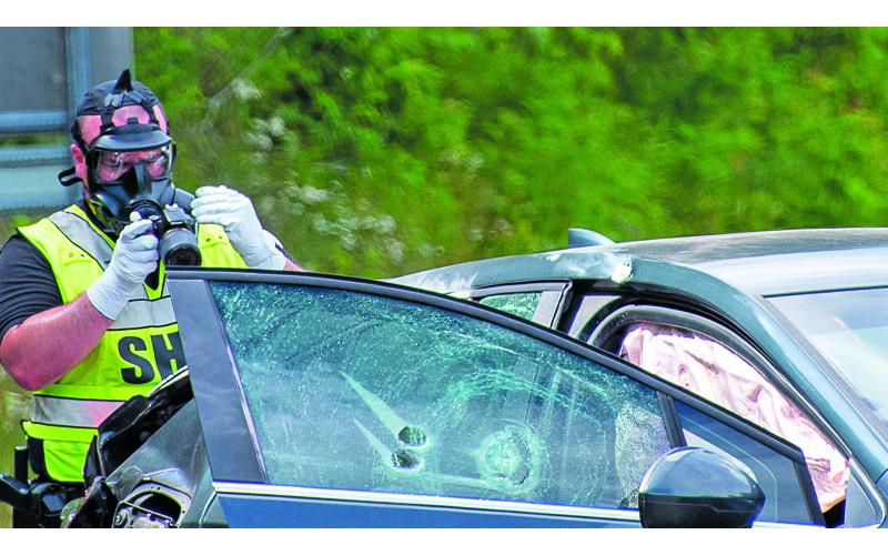 Photo/Bob Scott.  Law enforcement from multiple agencies converged on Highway 64 in Macon County as they stopped Kelvin Simmons, who is charged in the shooting death of a detention officer in Cherokee County. Simmons led officers on a chase through Clay County into Macon County Monday afternoon.