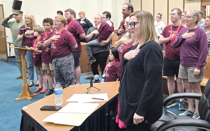 SMT photo/Sara Eisinger.  Swain County Manager Lottie Barker pledges her allegiance to the American flag at a commissioners meeting Tuesday, May 6.