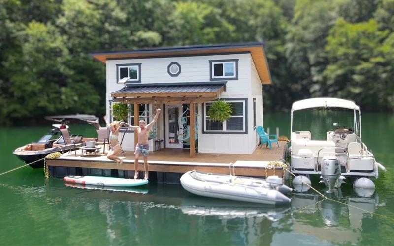 Photo/Brandon Jones.  Brandon and Sarah Jones jump off the dock of their Fontana Lake home in summer 2023. The Joneses 360-square-foot floating cabin and surrounding 400-square-foot dock was completed in spring that year.