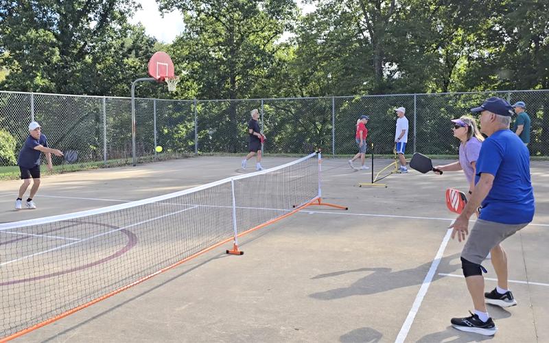 SMT photo/Sara Eisinger.   Al Desilets, Bryson City Pickle Ball organizer, returns a volley from Andrea Hachtel at a Swain County Recreation Park court Monday, Aug. 25. Bryson City Pickle Ball members play seven days per week.