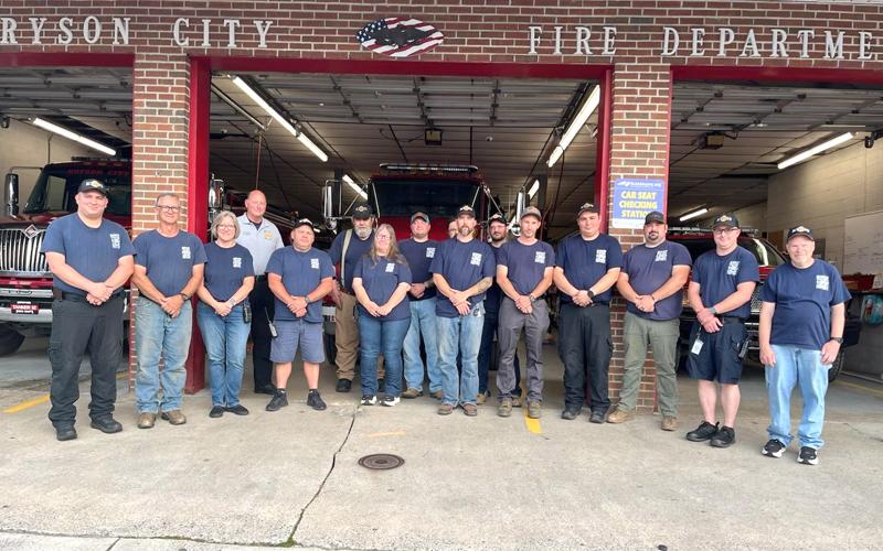 Submitted photo.  Cain Arch (front, left to right), Chuck Taylor, Donna Taylor, Jeremy Shuler, Cindy Cody, Jason Kosinizak, Daniel Cochran, Tyler Taylor, Justin Cline, Phillip Carson Jr, Michael Colcord; Charles Bryson (back, left to right), Jeff Gasaway, Kevin Bryson, James Crisp and Jimmy Collins outside Bryson City Fire Department in summer 2025.