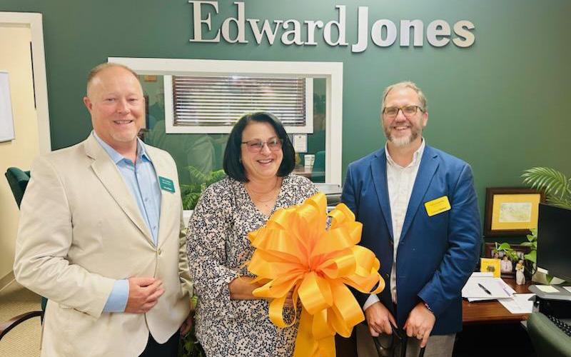 Submitted photo.   Robert Loafman (left to right), Joyce Wilkie and Ted Goshorn celebrate the expansion of Edward Jones in Bryson City with Swain County Chamber of Commerce Thursday, Sept. 18.