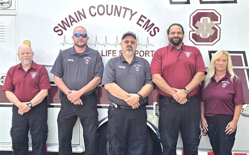 SMT photo/Sara Eisinger.  Swain County EMS first responders Steve Pack, Brandon Wiggins, Jon Waldroup, Ian McCauley and Earlene Leonard remember 9/11 outside the EMS building Sept. 5.