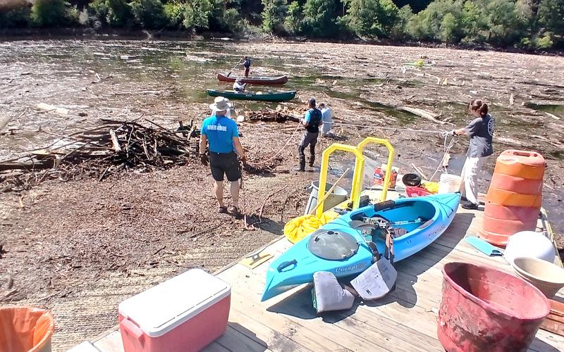 Photo/Nick Nichols.  Volunteers cleanup around David Monteith County Park boat launch after Hurricane Helene last year.