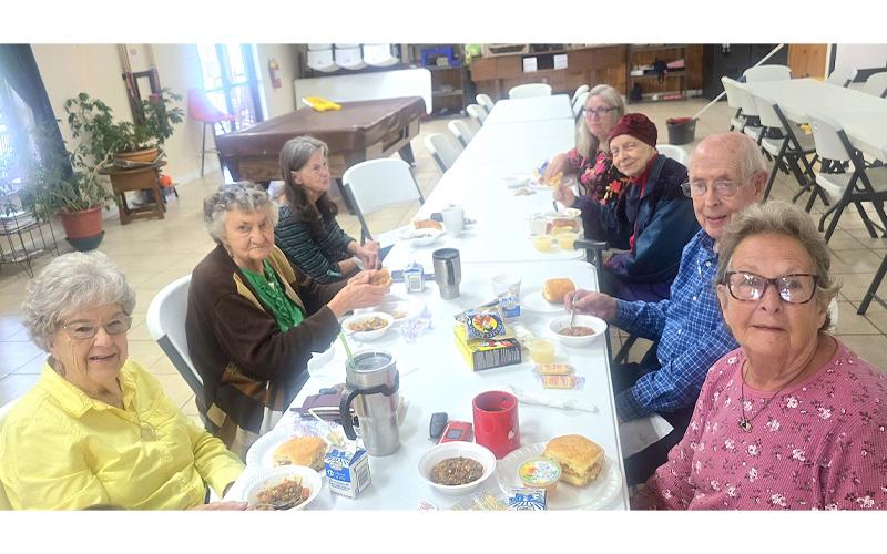 SMT photo/Sara Eisinger.  Gail Dellinger (left, front to back), Jeanette Frady, Linda Vaughn; (right, front to back) Margaret McCurry, Richard Schaddelee, Judy Stroup and Sandy Estep congregate for lunch at Swain Senior Center Monday, Sept. 15.