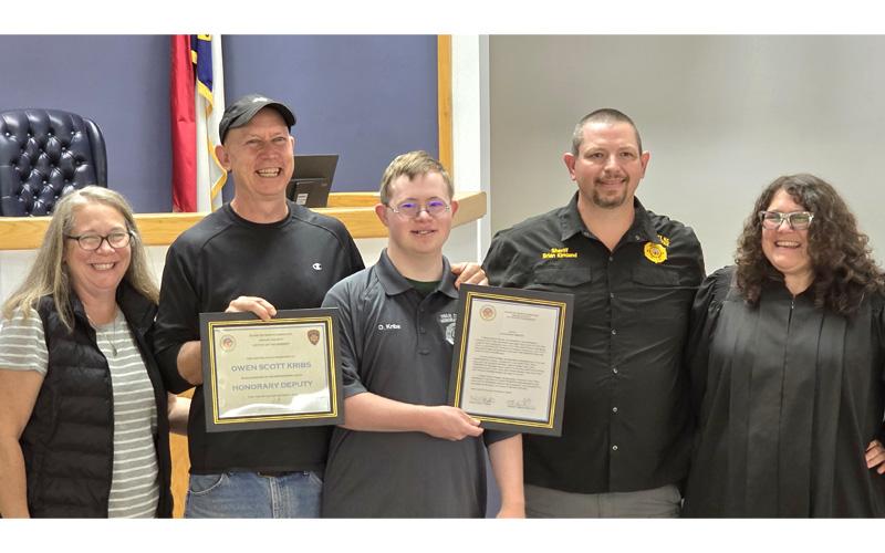 SMT photo/Sara Eisinger.  Windy (left to right), Scott and Owen Kribs after swearing in as a Swain County Sheriff’s deputy with Sheriff Brian Kirkland and District Court Judge Kristy L. Parton Oct. 3.