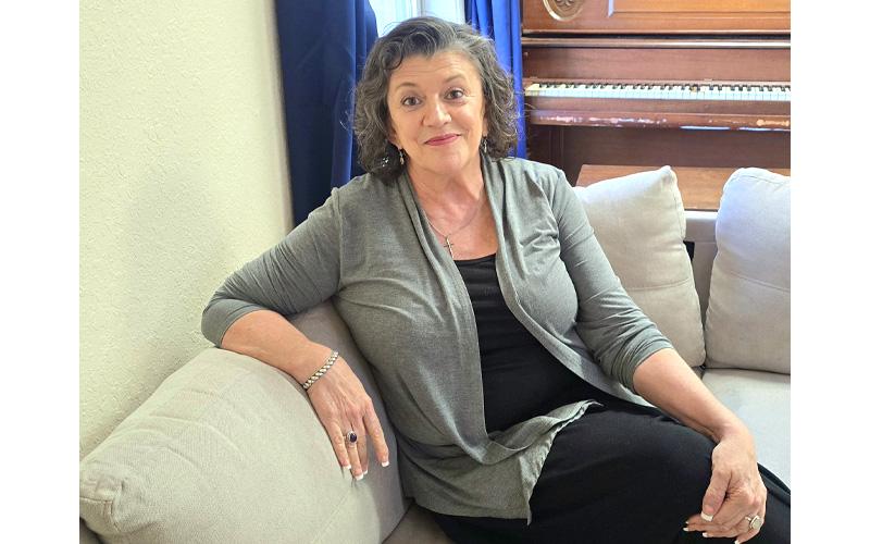 SMT photo/Sara Eisinger. Rhonda Jenkins rests on a sofa while visiting Swain Senior Center Oct. 3.