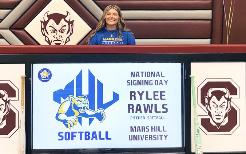 Photo submitted.  Rylee Rawls, senior at Swain High School, accepts offer to pitch for Mars Hill University during a high school gathering Nov. 13.