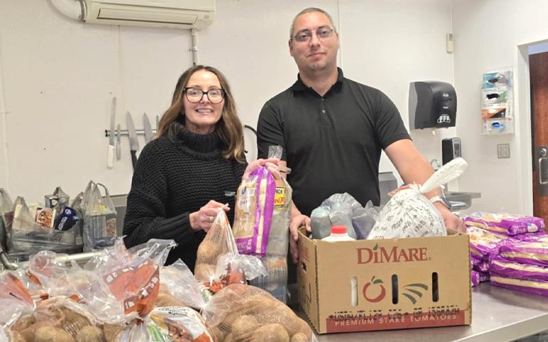 Photo submitted.  WNC Lighthouse founder and director Melinda Shuler, MHS donates Thanksgiving food boxes to the Chris Morrison Family at Camp Living Water.