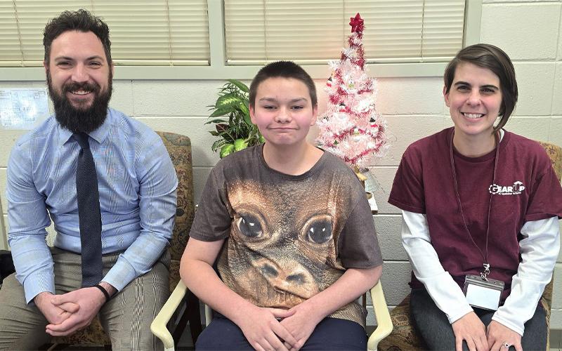 SMT photo/Sara Eisinger.  Principal Ryan McMahan (left to right), seventh-grade student Dakota and GEAR UP coordinator Taylor Rae Dodge Brown at Swain Middle School Tuesday afternoon. Johnson was nominated as a recipient of the Victor E. Bell Scholarship recipient.