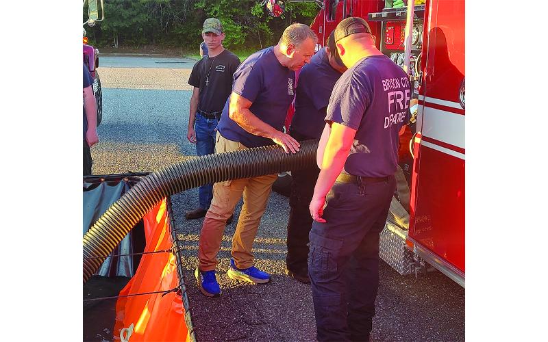 Photo/Charles Bryson.  Bryson City firefighters practice fire scene setup for North Carolina Office of State Fire Marshal inspection in the Ingles Market parking lot May 6.