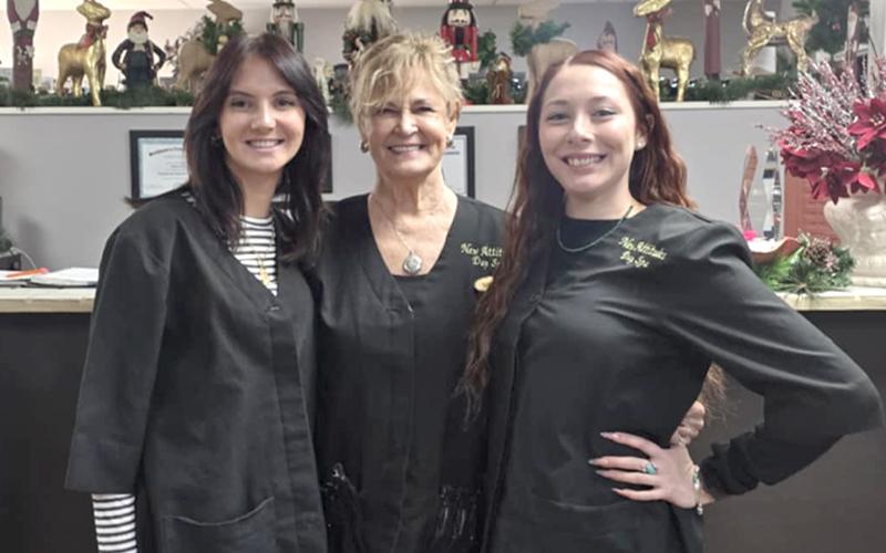 SMT photo/Sara Eisinger.  New Attitudes Day Spa’s Aliyah Stewart (left to right), Nancy Jones, owner, and Grace Cabe start the day with matching smiles Dec. 30.