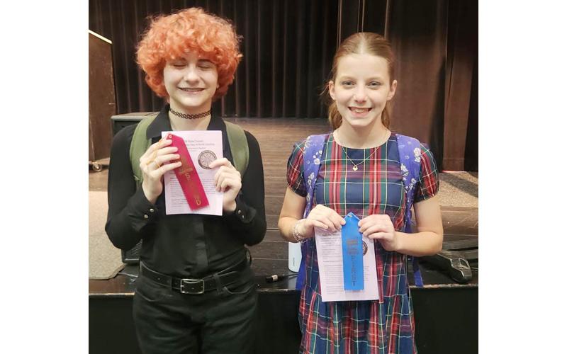 Photo Submitted.  Madison Weston, eighth grade, (left to right) stands alongside Elsie-Mae Clayton, seventh grade, (not pictured is Avery Roland, ninth grade) at Regional National History Day in Hendersonville in March 2026.