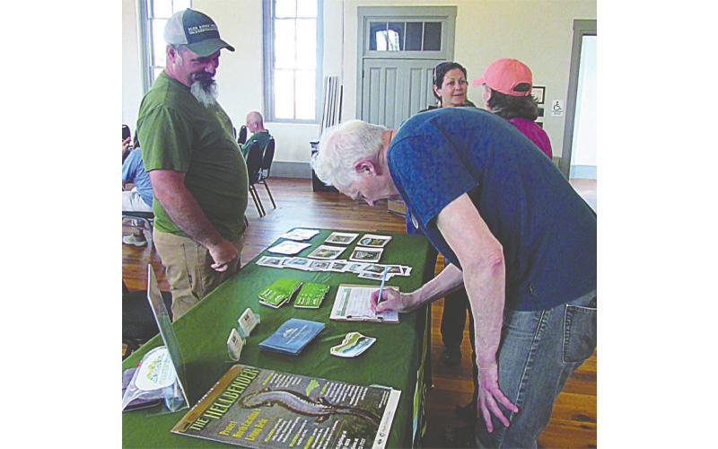 Lorraine Bennett, Clay County Progress. Rob Tiger signs in for Thursday evening's town hall on the Roadless Rule. The meeting was held at the Historic Courthouse Beal Center.