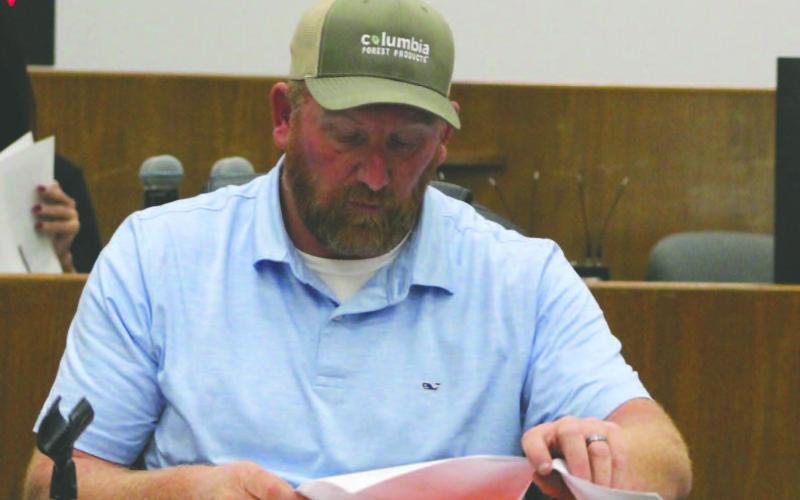 Press photo/Shelby Powell. Swain commissioner Jay Kirkland reviews a budget request made by the Swain County school board in a joint meeting between the two boards.