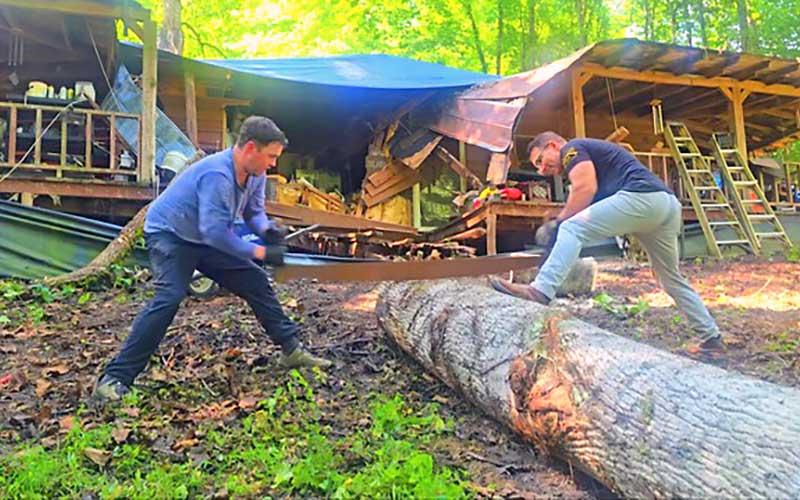 Photo/Sara Eisinger - Veterans Sean Parrish and Richard Sneed of Appalachian Warrior Tribe clean up debris June 11.