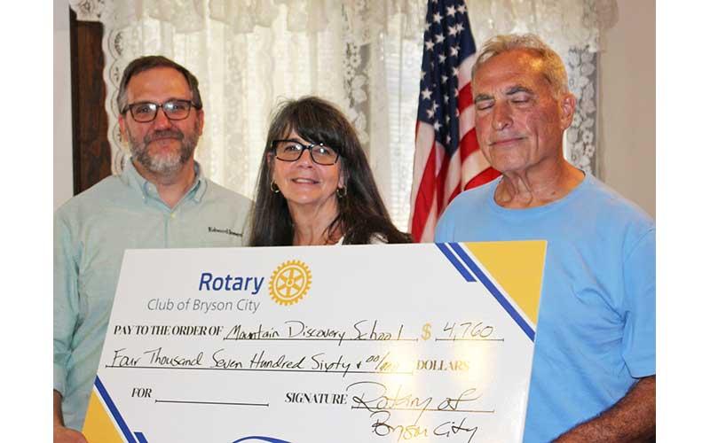 Photo/ Deb Stuart - Ted Goshorn (left to right), Billie Clemens and Nick Nichols hold literacy check for Mountain Discovery Charter School at the Historic Calhoun House June 4.