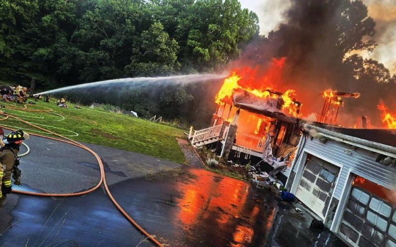 Firefighters participate in live-burn training off DeHart Cove Road June 23.