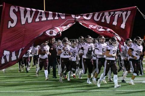 The Swain County Maroon Devils varsity football team takes the field against Hayesville.
