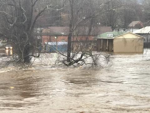 The Tuckasegee River overflowed its banks on Thursday following 3-4 inches of rain. Pictured above, the river reaches beyond Island Street and up by Grumpy's Car Wash in downtown Bryson City. 