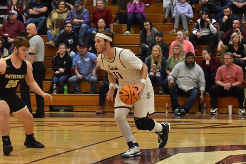 Maroon Devil Aiden Pond looks for his next move down the court in the game against Hayesville Friday.