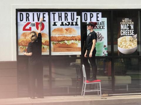Employees at Arby's post a sign on the window that reads "Drive Thru Open" following Gov. Roy Cooper's order last week that restaurants can no longer have dine-in service. It's one of many measures the government has put in place to try to stop the spread of coronavirus. 