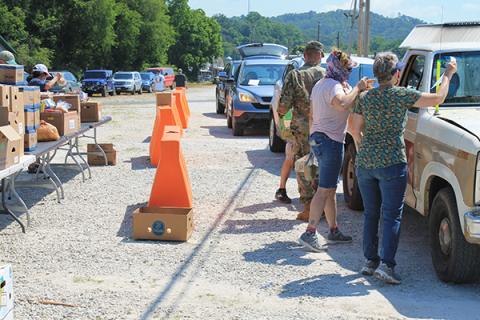Volunteers give out boxes at the drive thru pop up market