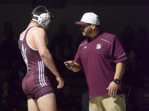 Adam Jaimez speaks to one of his wrestlers
