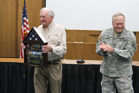 Philip Bailie accepts the shadow box from his son, Jim Bailie.
